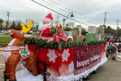 Inflatable Santa and reindeer and different kinds of Christmas gifts on a Christmas float in Germantown Christmas Festival parade.