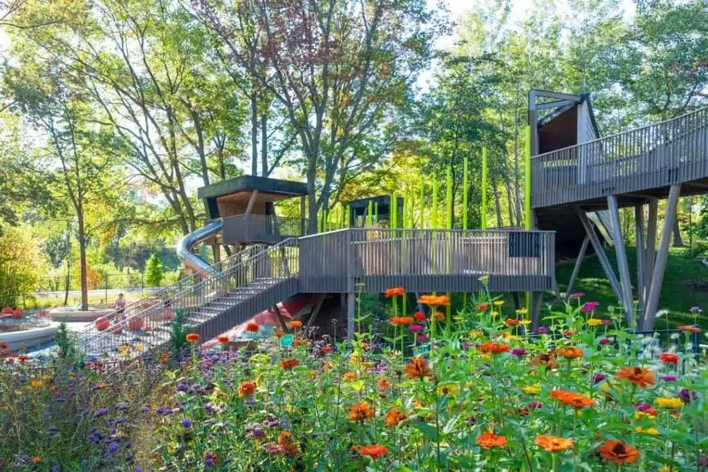 Colorful flowers surround elevated play structures at Green Bay Botanical Garden.