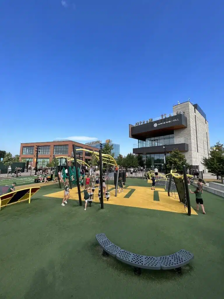 Kids playing at the modern Titletown playground near Lambeau Field in Green Bay.