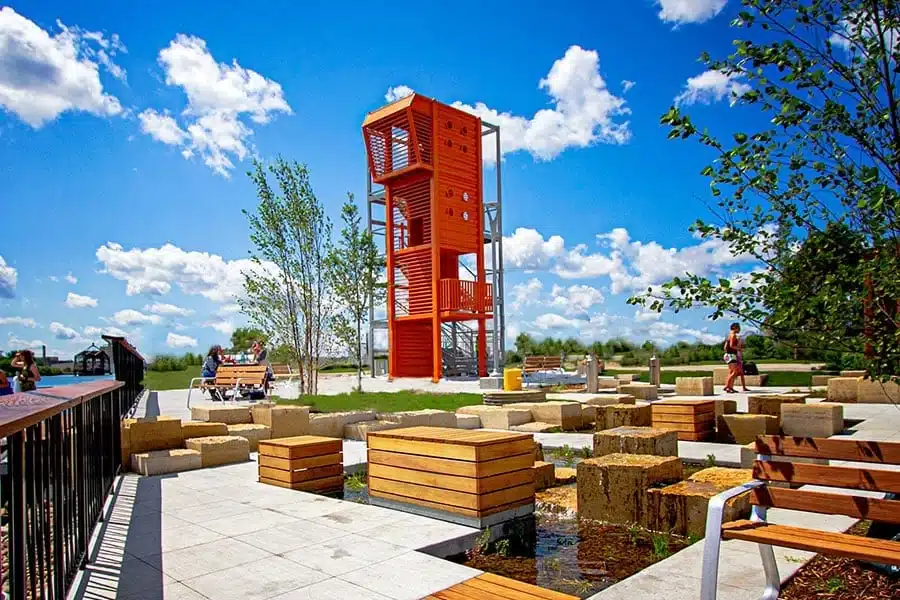 Bright orange play tower at Harbor View Plaza on a sunny day.