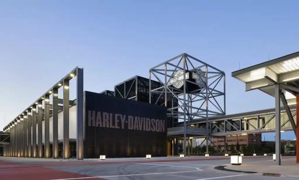 Exterior of the Harley-Davidson Museum with glass walls, steel beams and a large signage with the Harley-Davidson logo.