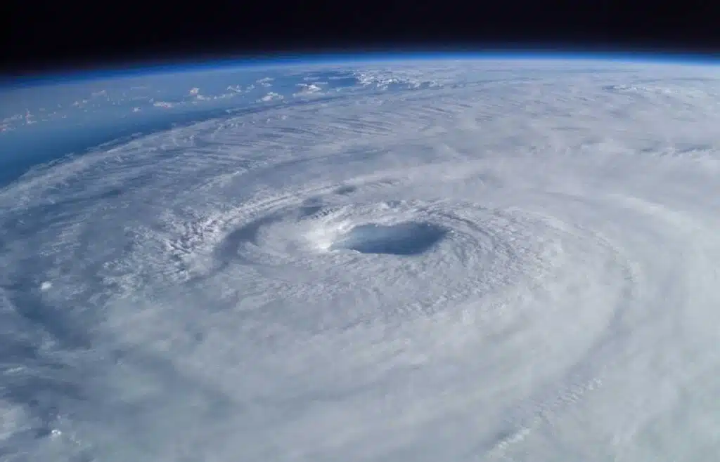 A massive swirling hurricane seen from space with a clear eye at the center.