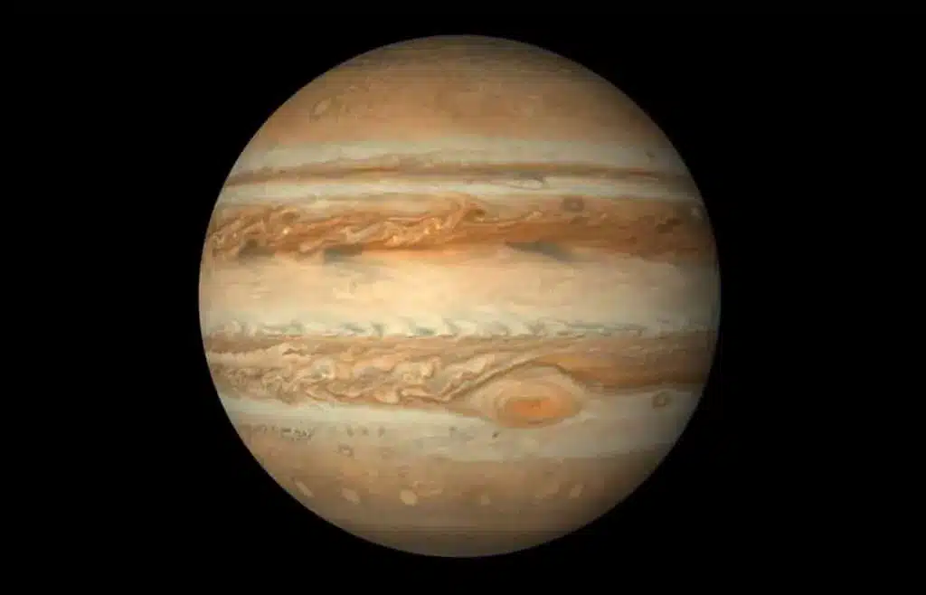 Jupiter with its giant storm, the Great Red Spot, visible on its surface.