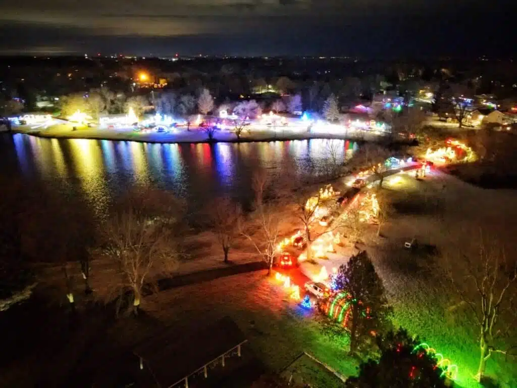Aerial view of the Zeunert Park that is brightly lit with Christmas decors and cars driving by to enjoy the scenery at Cedarburg Wisconsin