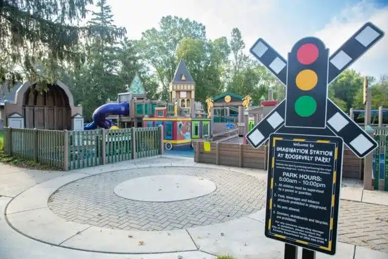Entrance sign and train-themed playground at Imagination Station in Oconomowoc
