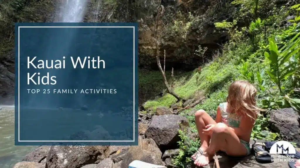 Child sitting near a falls in Kauai, Hawaii and with a text inlay Kauai with Kids