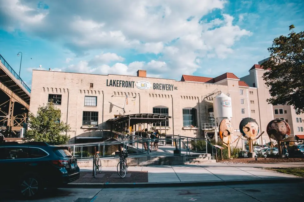 Lakefront Brewery in Milwaukee with outdoor seating, riverfront views, and visitors enjoying craft beer.