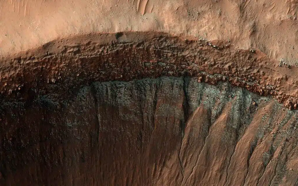 A close-up view of a massive and deep crater edge on Mars.