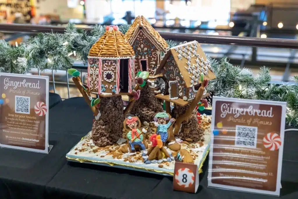 Three gingerbread houses were designed as tree houses, and two gingerbread kids were roasting marshmallows on a bonfire.