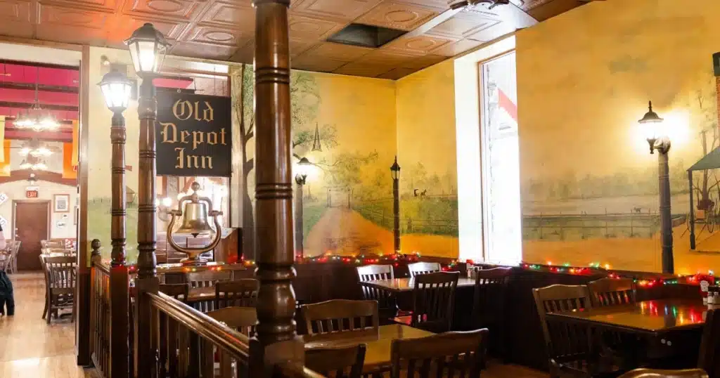 Dining area of Maxims featuring a painted wall mural