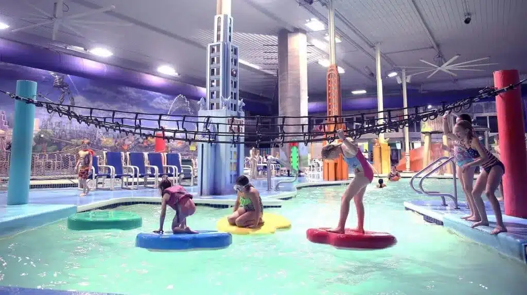 Kids balancing on floating pads at Metropolis Resort water park