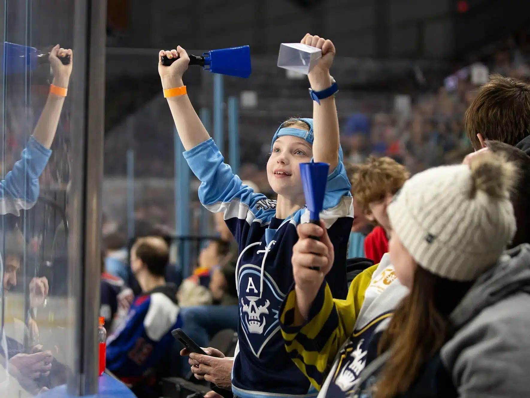 Young fan cheering at a Milwaukee Admirals hockey game