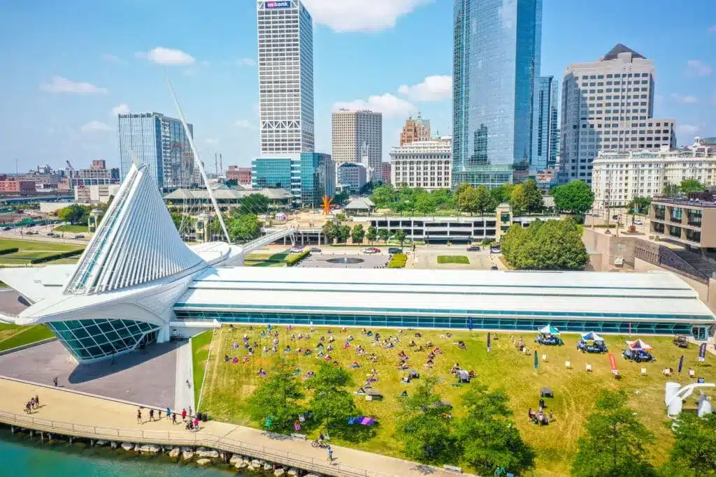 Milwaukee Art Museum exterior with kids playing on lakeside lawn