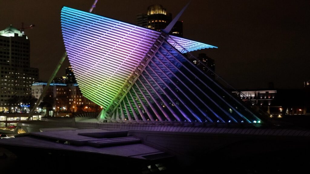 Burke Brise Soleil wings being lit up at night in gradient colors of blue, green, purple and yellows