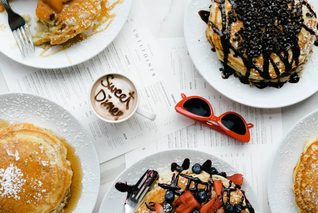 Brunch pancakes with blue berry, maple syrup and strawberry toppings and coffee at Sweetdiner in Milwaukee