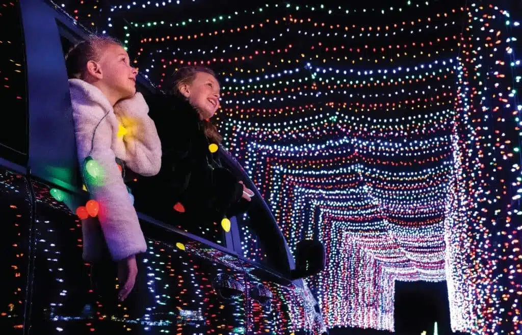 Two girls rising the car and watching the drive-through Christmas lights in Milwaukee