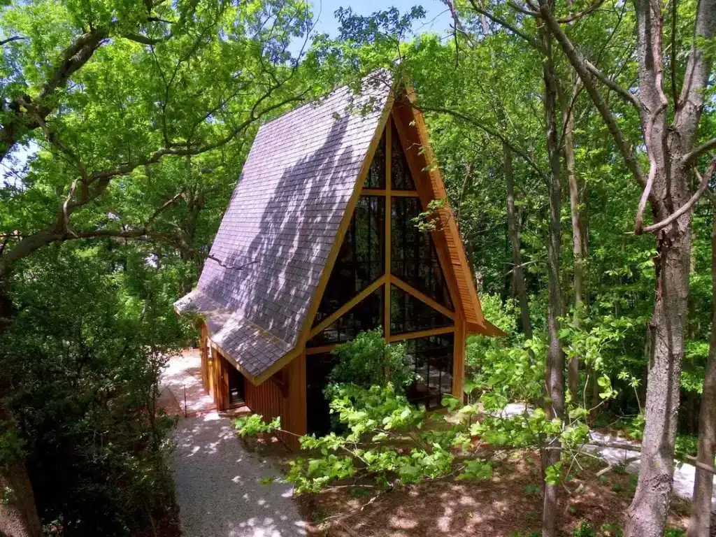 A-frame healing chapel sits quietly among the summer trees at the Conservancy for Healing & Heritage.
