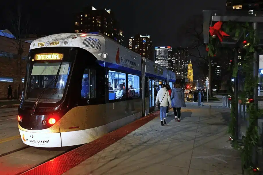 Streetcar decorated for the holidays as riders board during Milwaukee’s festive Holidays on The Hop event.