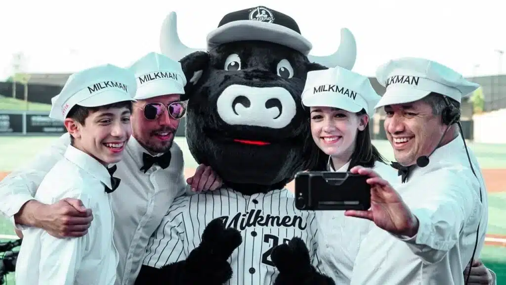 Fans posing with Bo Vine, the Milwaukee Milkmen mascot, at Franklin Field