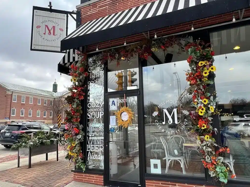 Garlands of fresh flowers hanging on the glass windows of Miss Molly;s Cafe and Pastry Shop