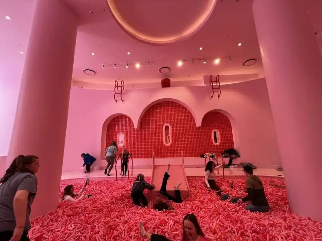 Visitors play in a large pink sprinkle pool inside the Museum of Ice Cream in Chicago.