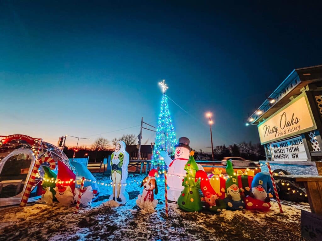 Inflatable Christmas elves, snowman and dog with Santa hat greet guests at Natty Okas Pub and Eatery