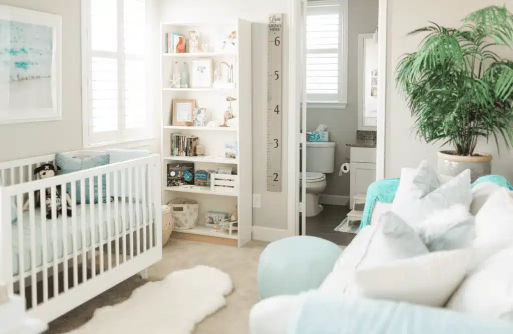 Ocean gender-neutral nursery with pirate plushie and blue pillows and blankets