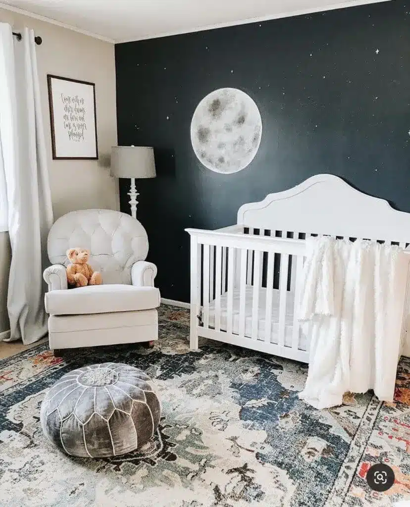 Outer space gender-neutral nursery with moon mural and classic teddy bear on chair