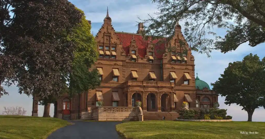 The exterior of the Pabst Mansion in Milwaukee with its vast driveway and large trees