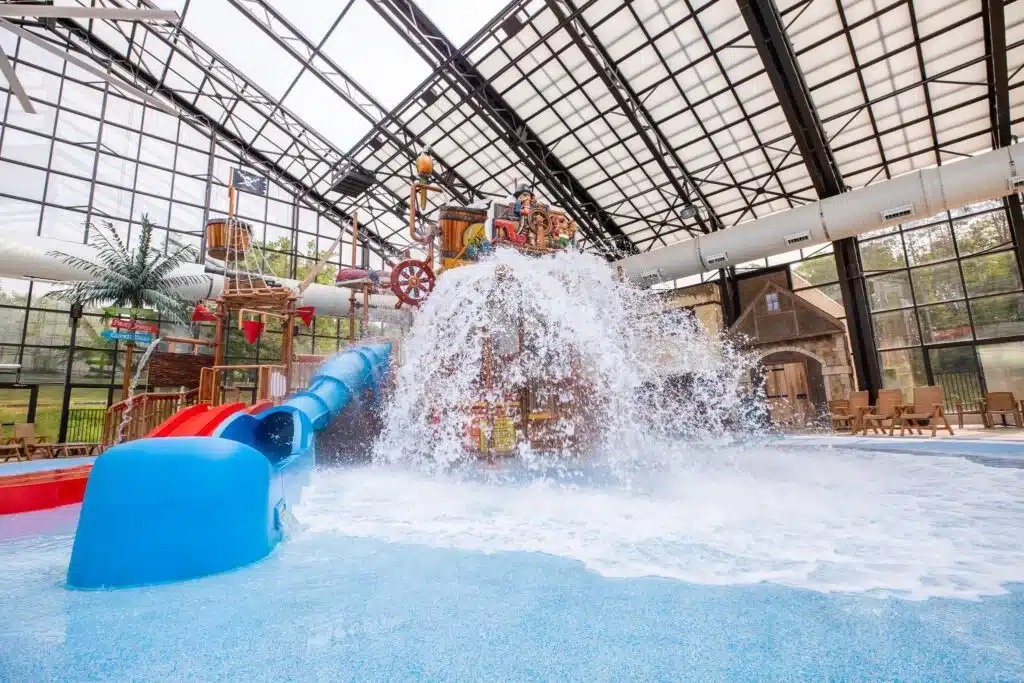 Indoor pool with red water slides at Pirate’s Cay Holiday Inn
