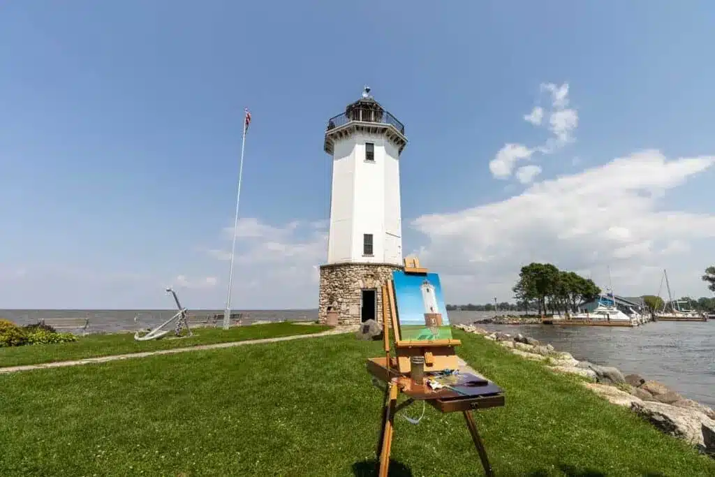 Port Washington Lighthouse overlooking Lake Michigan with painting easel