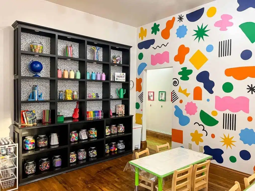 Joyosity Creative Space in Brookfield with kids tables and colorful wall mural