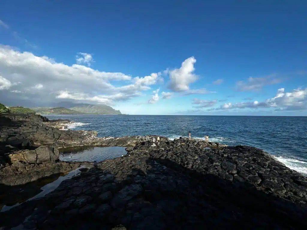 Kids checking out the rock pool at Queen's Bath Kauai