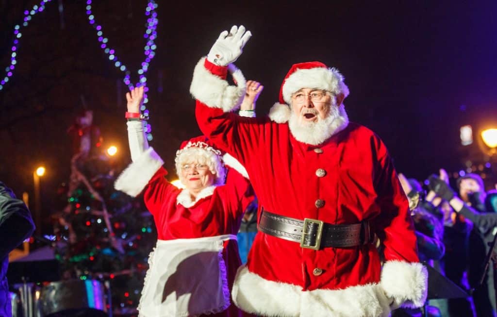Santa and Mrs Claus waving at people at a Meet Around Santa event in Milwaukee