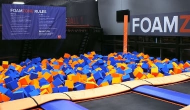 Orange and bllue foam squares inside a foam pit in Sky Zone ready for kids to jump into.
