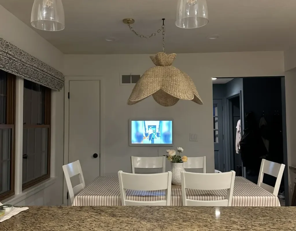 Skylight Calendar in screensaver photo mode at night in a dining room