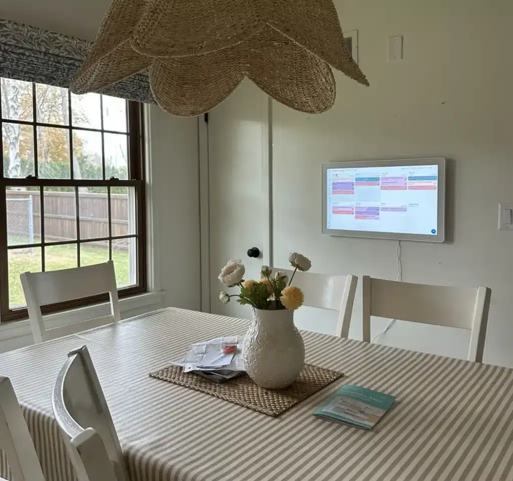 Skylight Family Calendar mounted in a family kitchen above a dining table