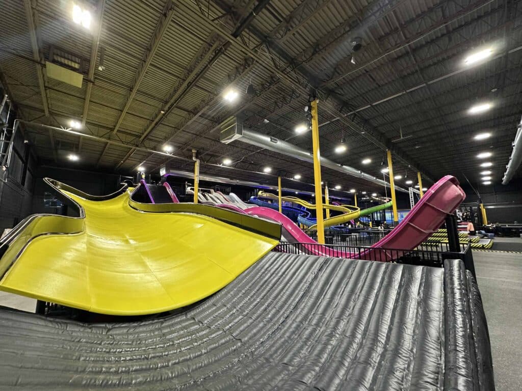 Yellow painted sry slide inside Slick City Action Park in Milwaukee