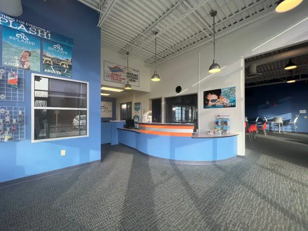 Front desk and lobby area, showing check-in counter and seating.