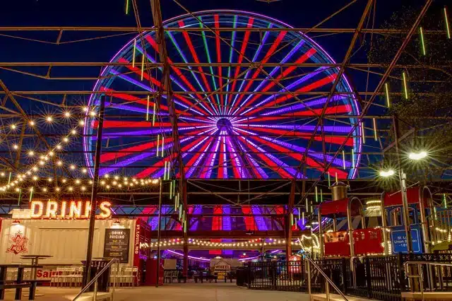Ferris wheel glowing at night at St. Louis Union Station
