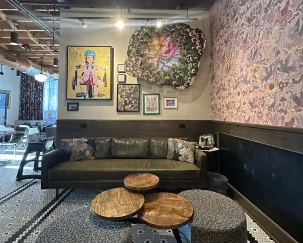 Dark green leather couch with posters on the wall at the Stone Creek Coffee at Whitefish Bay
