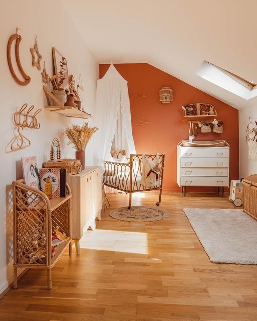Baby boy nursery with vintage map wallpaper, natural wood crib, and blue dresser – adventure and travel themed nursery idea for 2025