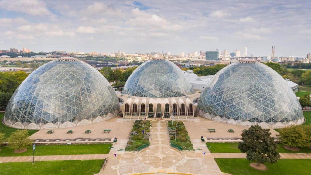 An aerial view of The Domes of Mitchel Park Horticultural Conservatory with a large garden in the middle.