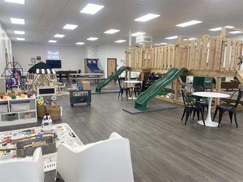 Green slides, tents and air hockey for eager children to play at The Spot