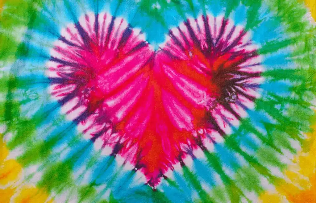 Close-up of tie-dye shirt with red heart design