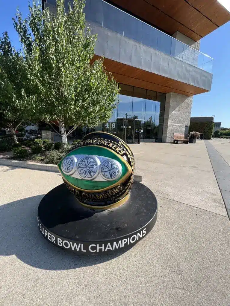 Marker that says Green Bay Packers Superbowl Champions in front of the store front side of 46 Below Cafe