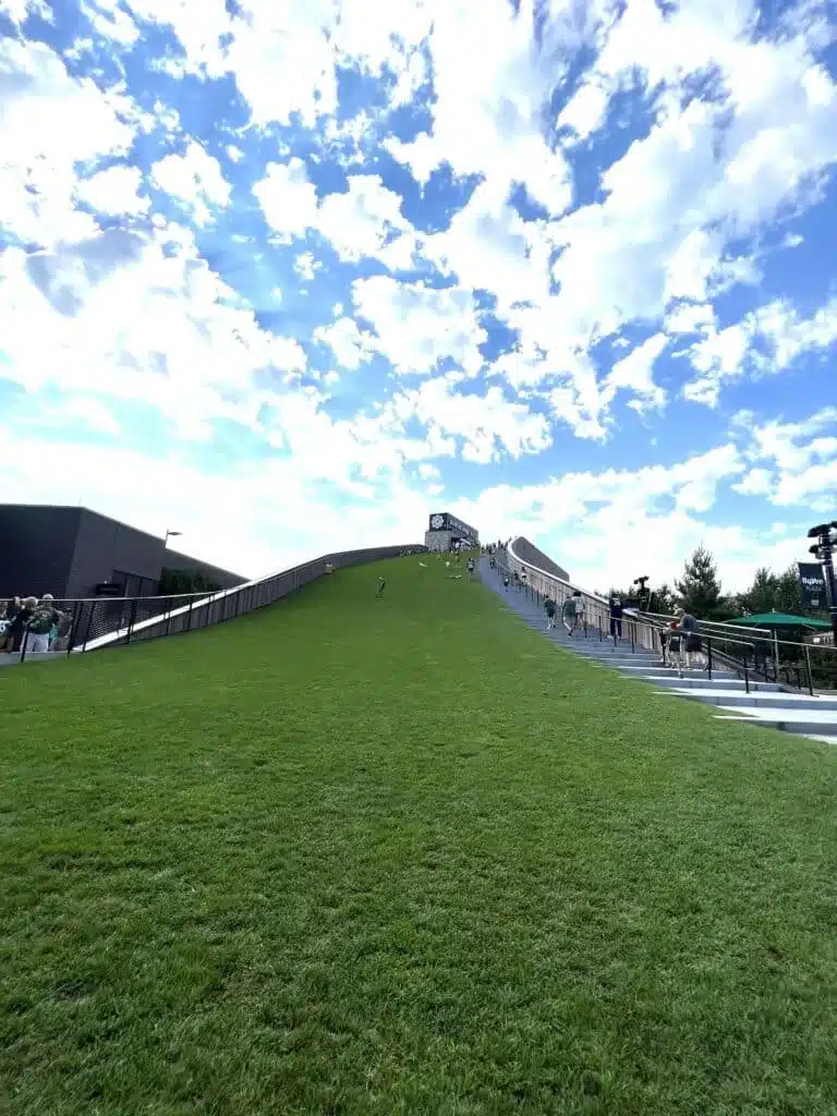 Families go up Ariens Hill via its grassy areas and stairs 