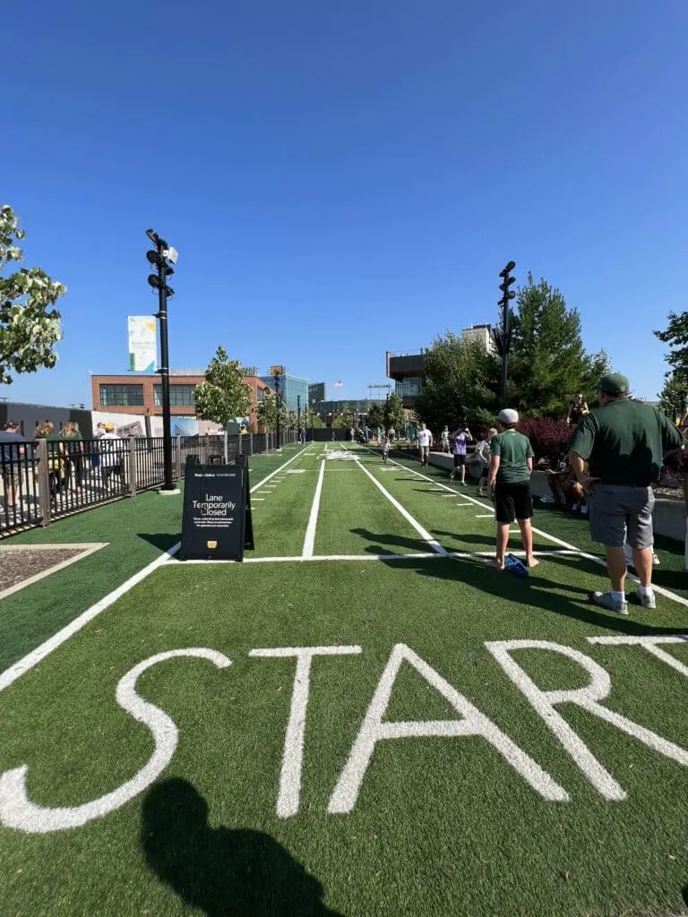 Kids ans their fathers standing at the starting point of 40-dash track with a label that says lane temporarily closed