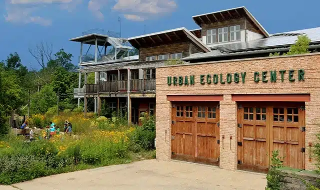 Exterior of the Urban Ecology Center at Riverside Park Milwaukee,with rustic wood-and-brick architecture and native gardens