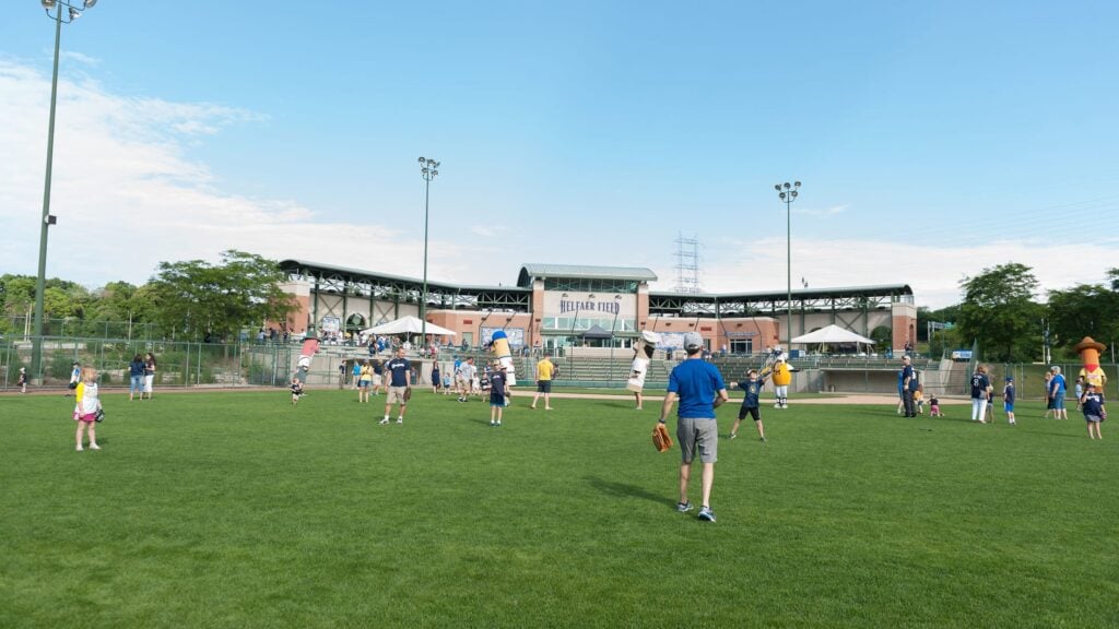 Players play baseball at Helfaer Field on the site of the old County Stadium outside American Family Field in Milwaukee WI.